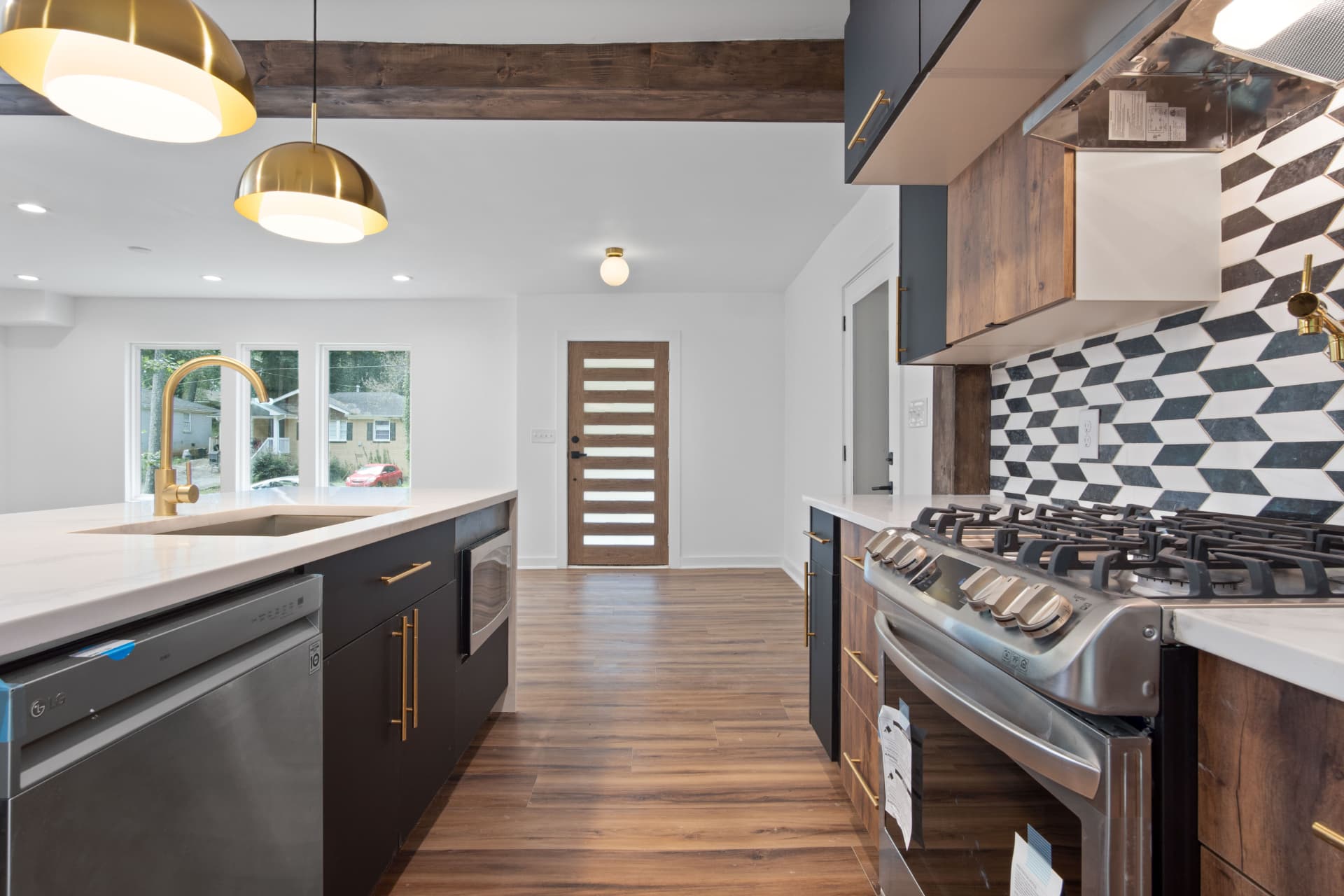 Galley view of kitchen with geometric tile backsplash