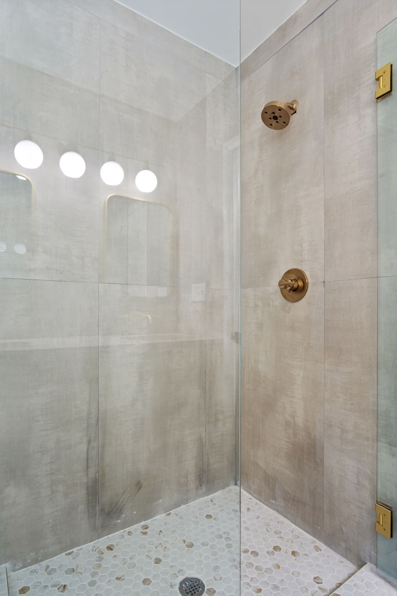 Walk-in shower with brass fixtures