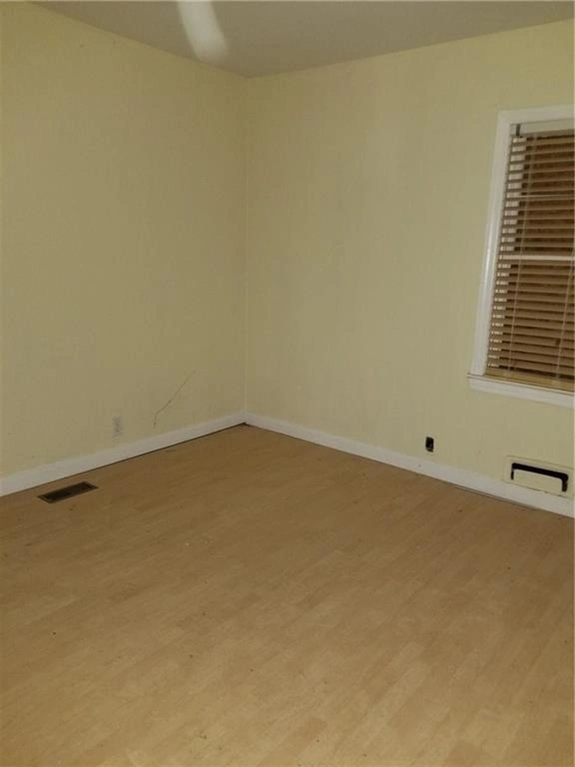 Original bedroom with dated blinds and trim