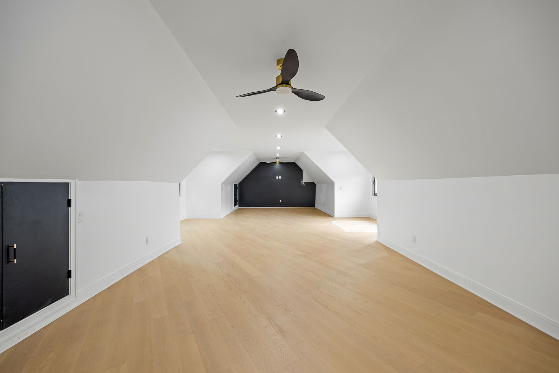 Bonus room above the garage with vaulted ceiling and black accent wall