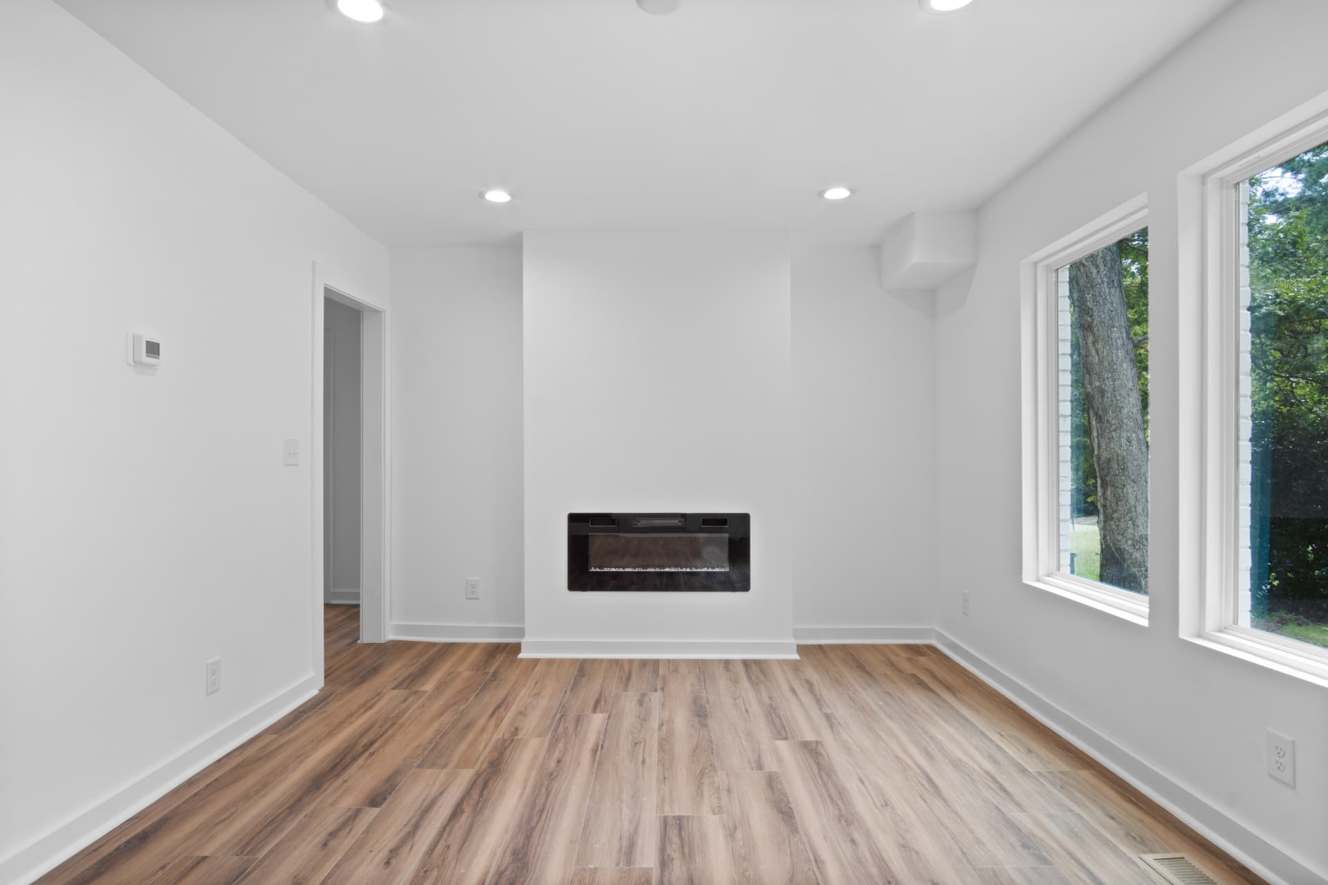 Living room fireplace wall with oversized windows
