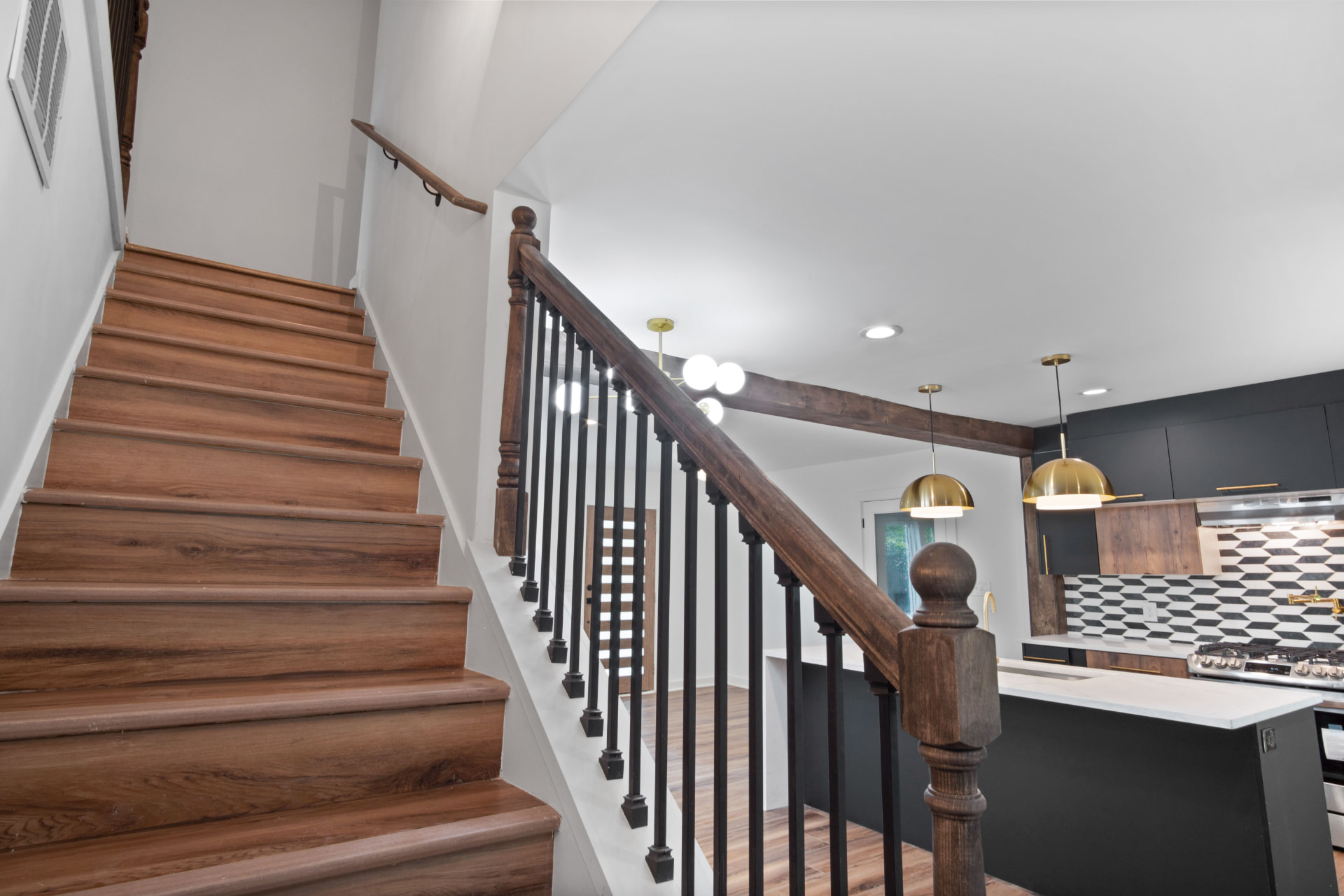 Stained oak staircase overlooking the kitchen