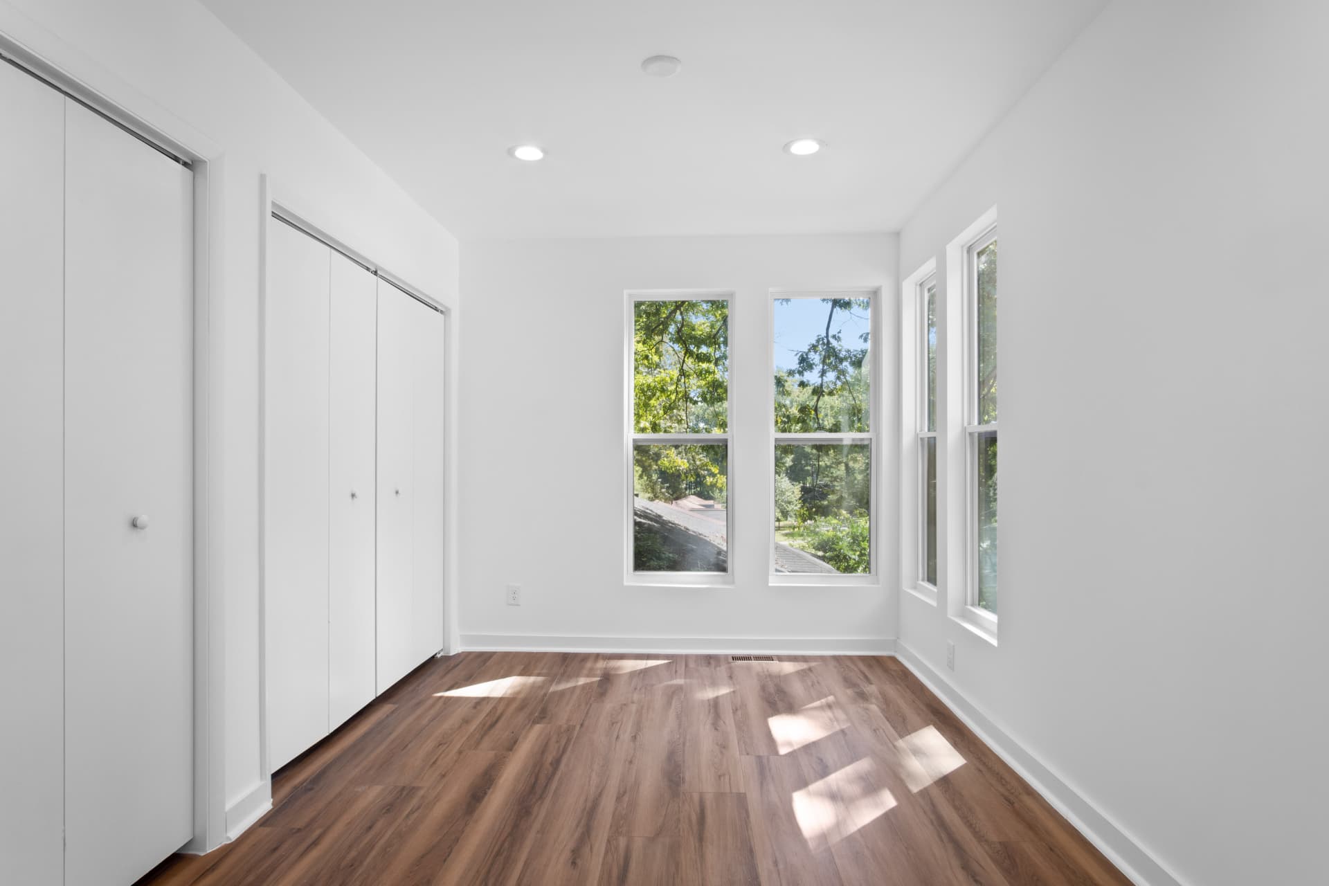 Bedroom with double closets and corner windows