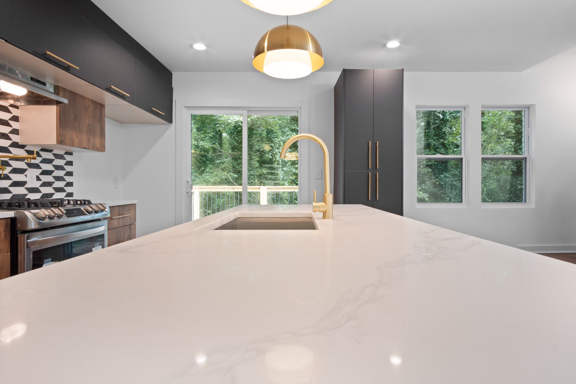 Quartz island with brass faucet and deck view