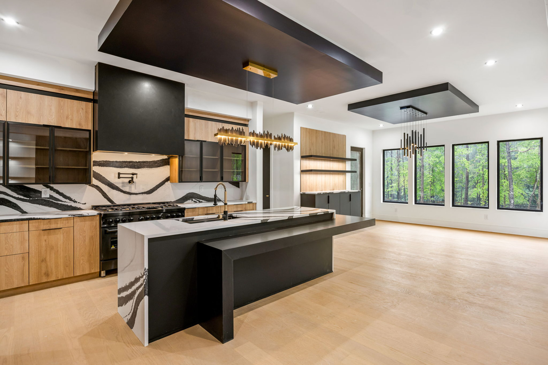 Kitchen island with waterfall quartz, black steel bar and sculptural linear pendant