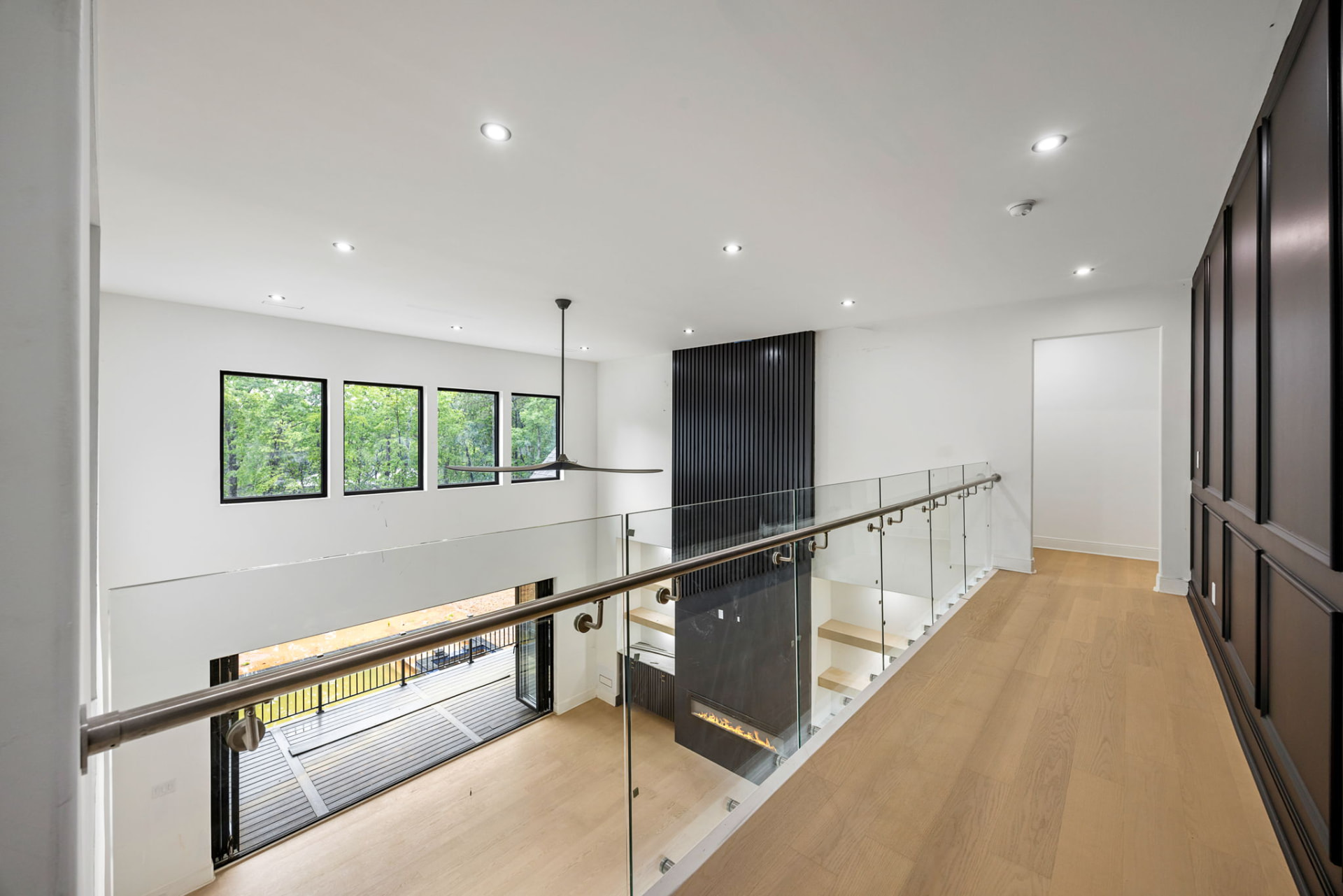 Catwalk overlooking the great room fireplace with glass railing