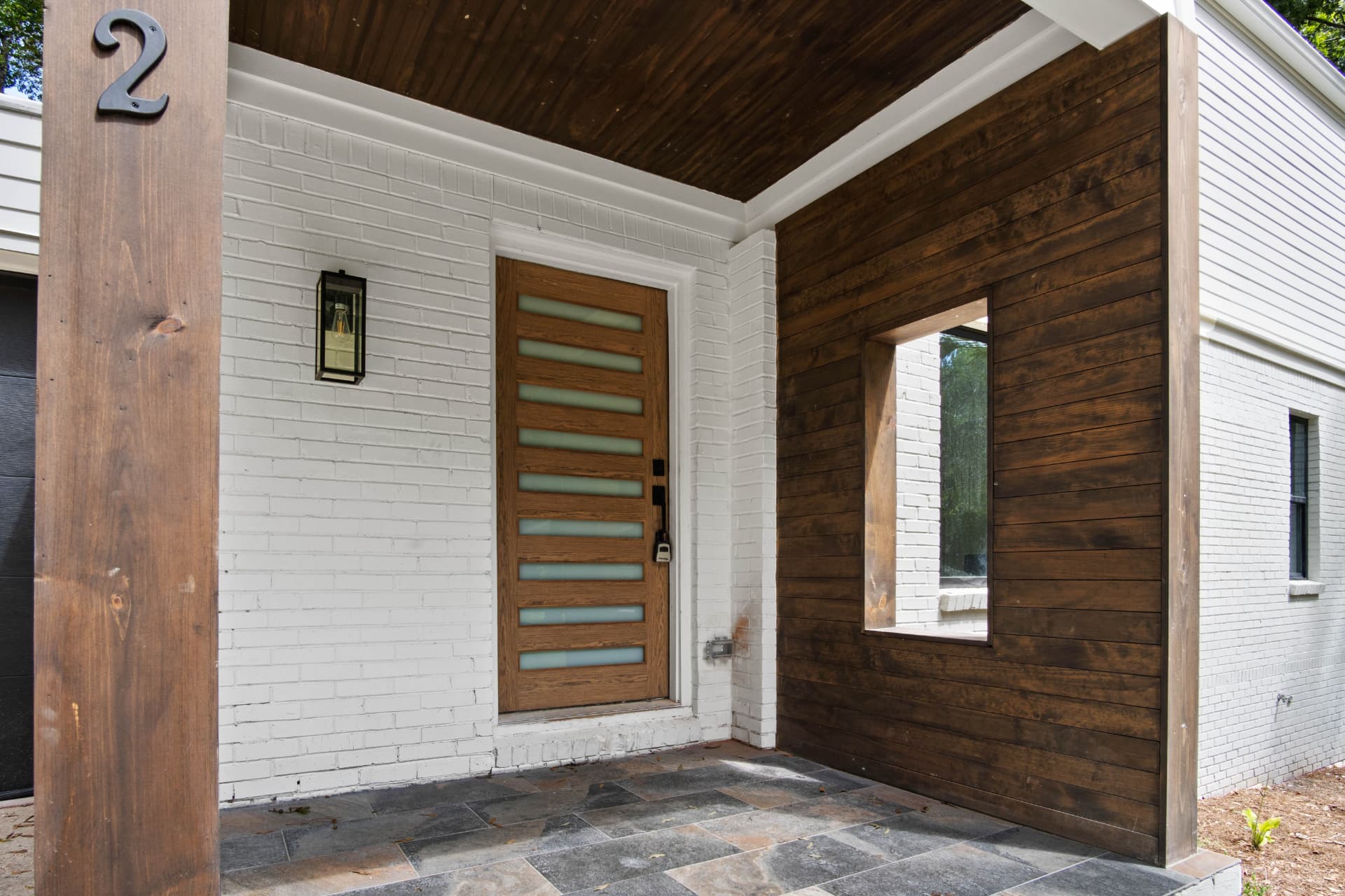 Covered entry porch with stained wood accents