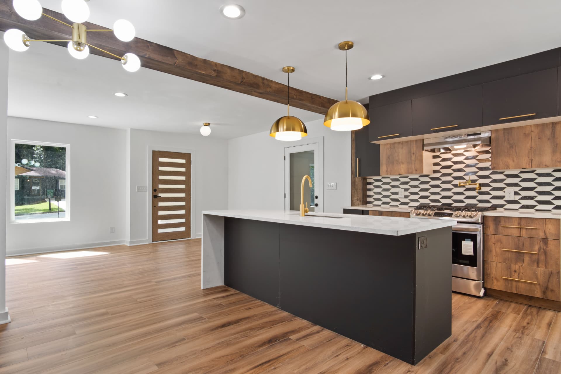 Kitchen and great room with exposed wood beam