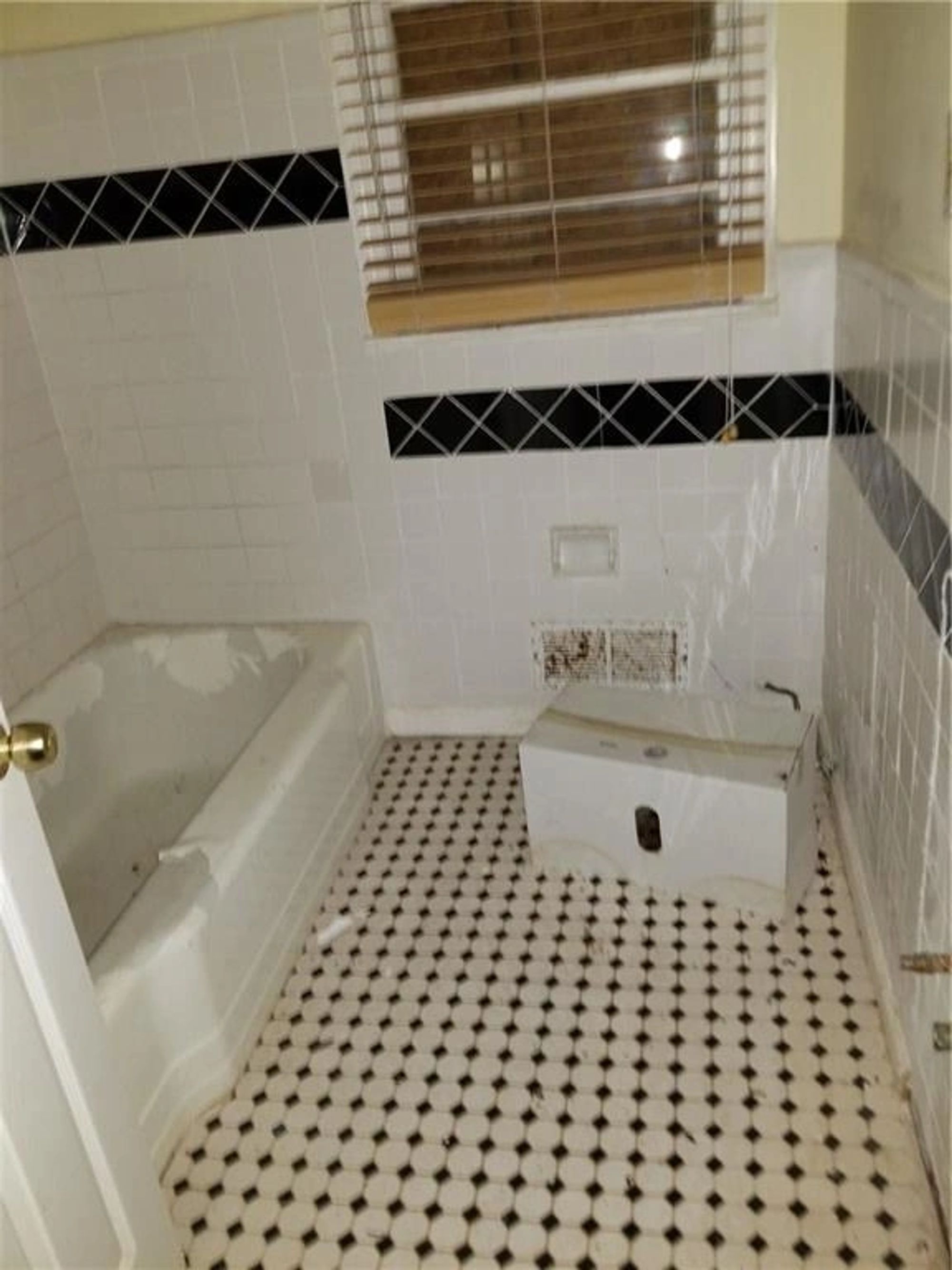 Original living area with damaged flooring